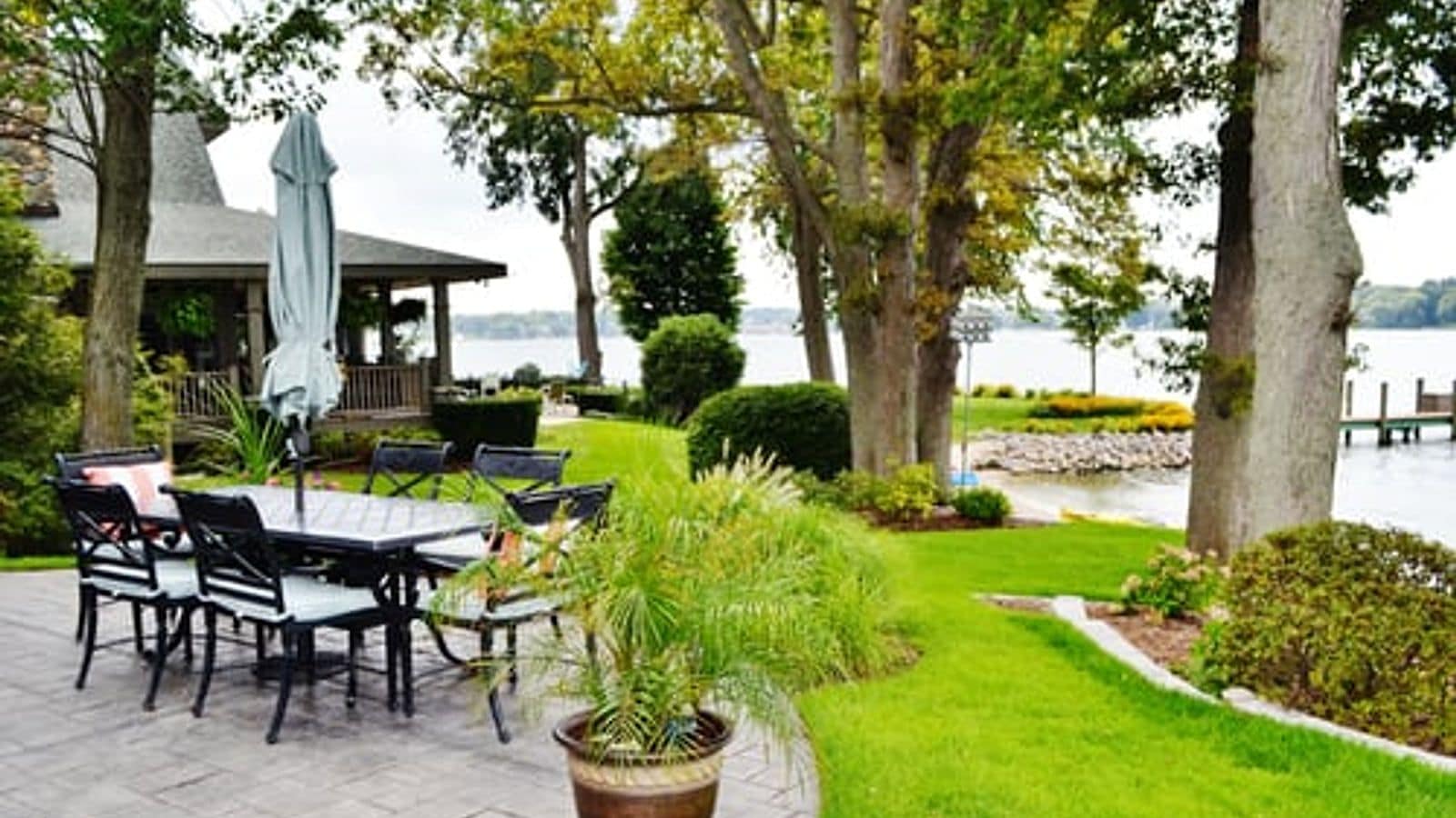 Manicured waterfront lawn and terrace on a Hamptons property cared for by All 4 Seasons Property Care